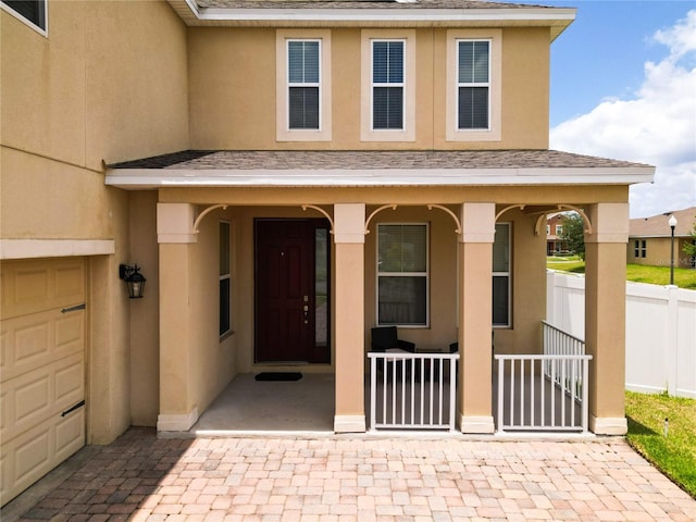 view of exterior entry with a porch