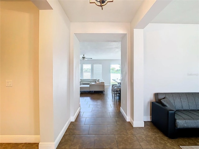 hallway with dark tile patterned flooring