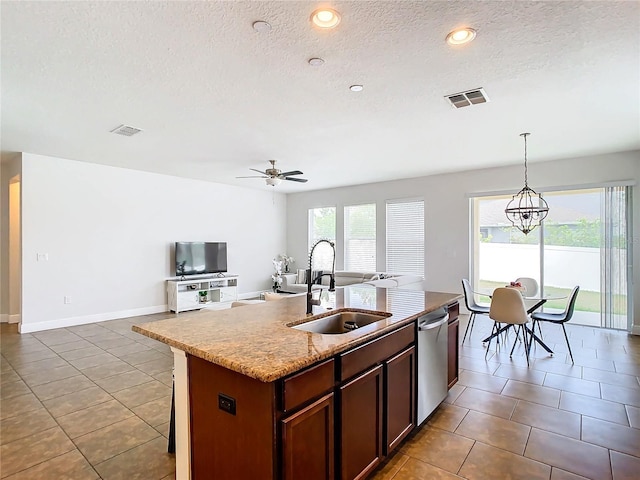 kitchen with dishwasher, sink, decorative light fixtures, a kitchen island with sink, and ceiling fan with notable chandelier