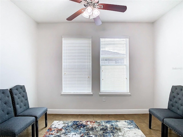 sitting room with ceiling fan and light tile patterned floors