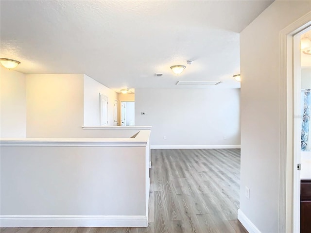 spare room featuring hardwood / wood-style floors and a textured ceiling