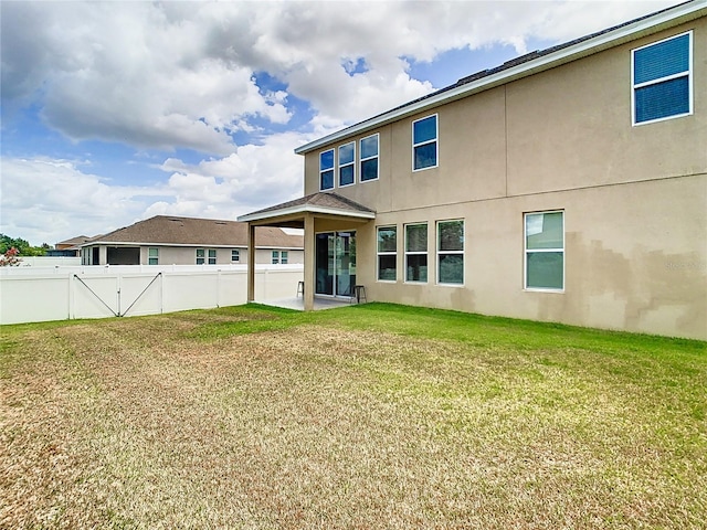 rear view of house with a lawn