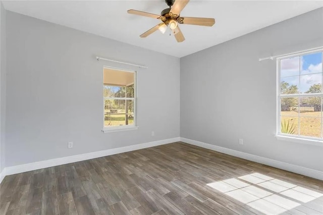 unfurnished room featuring a wealth of natural light, hardwood / wood-style flooring, and ceiling fan