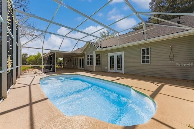 view of swimming pool featuring a patio, french doors, and a lanai