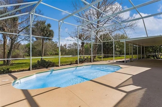 view of swimming pool featuring a patio area and a lanai