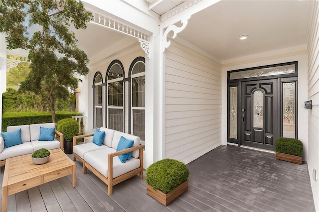 view of exterior entry with outdoor lounge area and covered porch