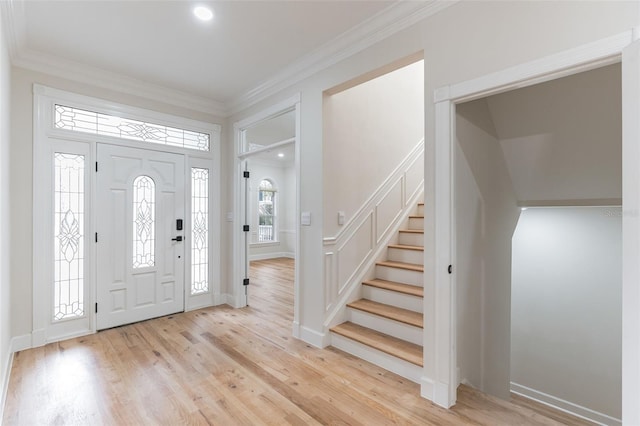 foyer with crown molding and light wood-type flooring