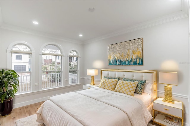 bedroom featuring light wood-type flooring and crown molding