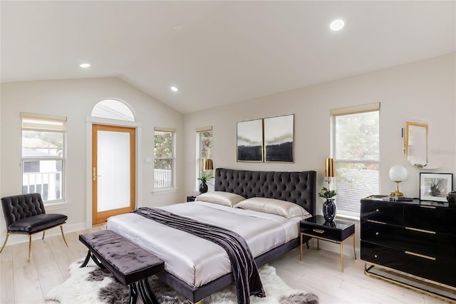 bedroom with light hardwood / wood-style floors, lofted ceiling, and multiple windows