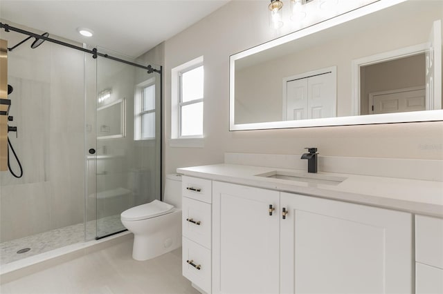 bathroom with vanity, toilet, and a shower with shower door