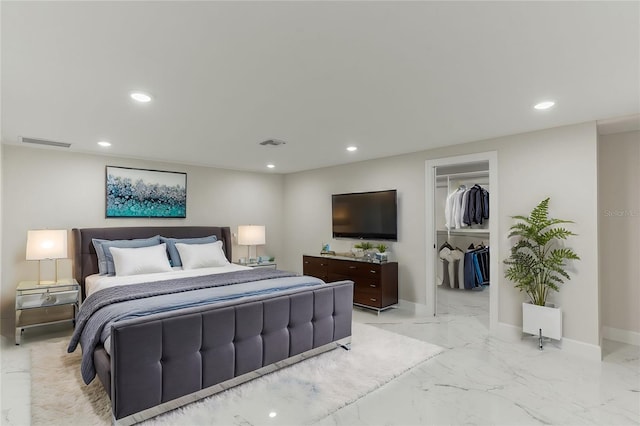 bedroom featuring a spacious closet and a closet