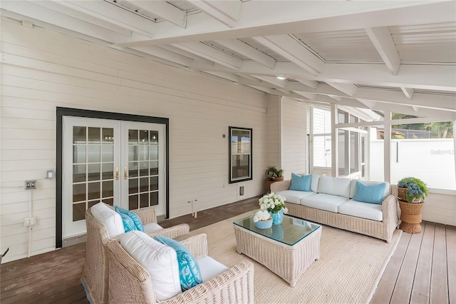 sunroom with beam ceiling and french doors