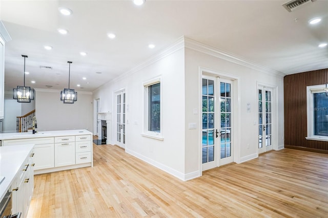 kitchen with visible vents, light countertops, french doors, white cabinetry, and pendant lighting