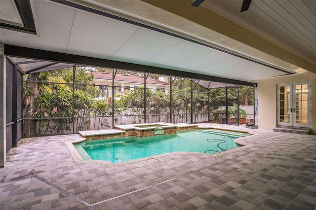 view of swimming pool with french doors, a patio area, a pool with connected hot tub, and a lanai