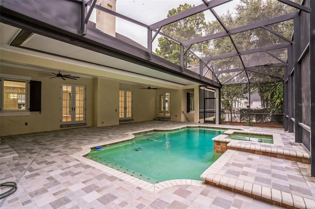 view of swimming pool with ceiling fan, glass enclosure, a pool with connected hot tub, french doors, and a patio area