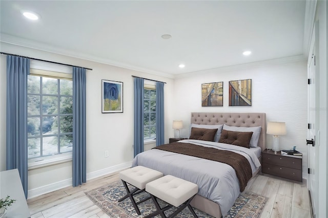 bedroom with light wood-style flooring, multiple windows, and crown molding