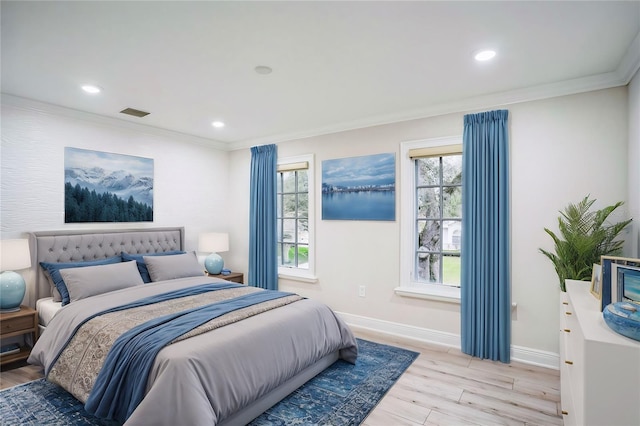 bedroom with baseboards, multiple windows, light wood-style flooring, and crown molding