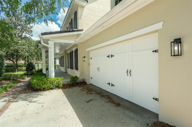 exterior space featuring driveway and stucco siding