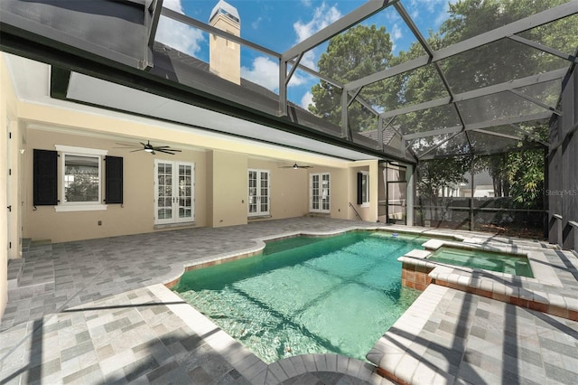 view of swimming pool featuring a patio, french doors, glass enclosure, ceiling fan, and a pool with connected hot tub