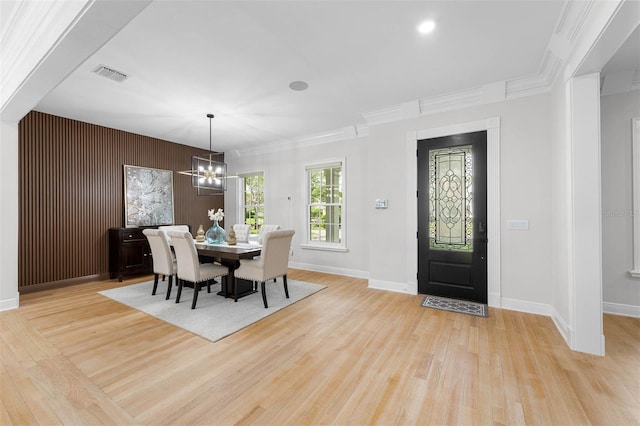 dining area with baseboards, light wood-style floors, a chandelier, and visible vents