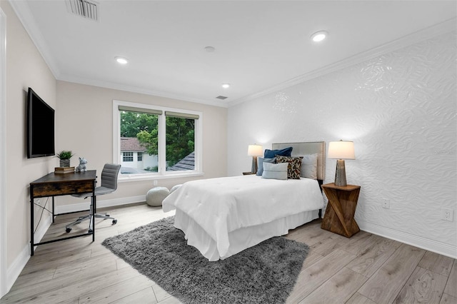 bedroom with light wood-style flooring, ornamental molding, and visible vents