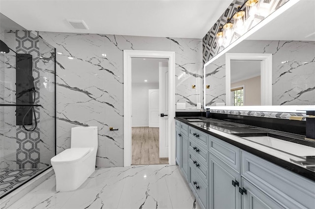 full bathroom featuring stone wall, marble finish floor, and a sink