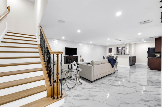 living room featuring stairs, marble finish floor, baseboards, visible vents, and recessed lighting