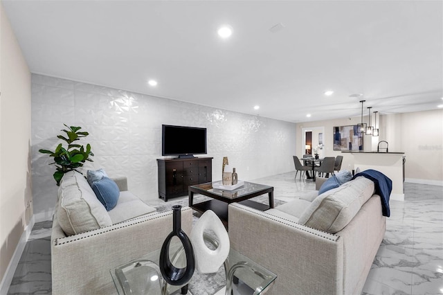 living room featuring baseboards, marble finish floor, and recessed lighting