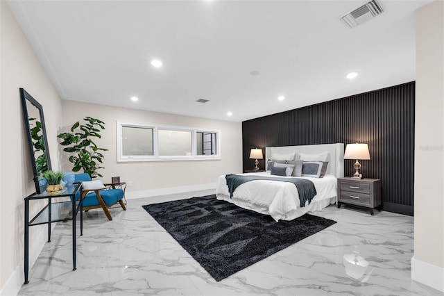 bedroom featuring baseboards, visible vents, an accent wall, and recessed lighting