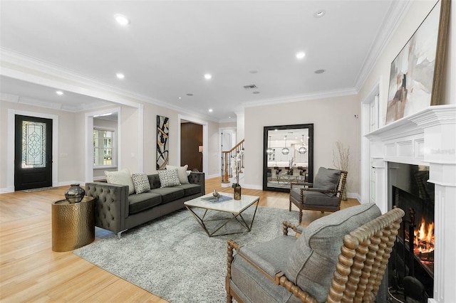 living room featuring crown molding, stairs, recessed lighting, light wood finished floors, and a high end fireplace