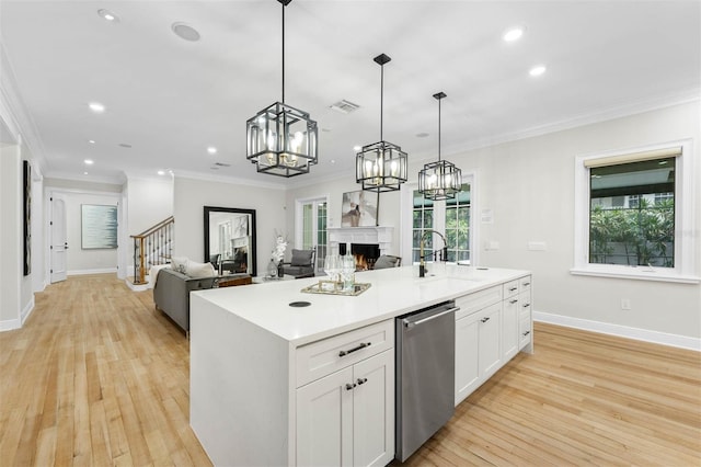 kitchen with a sink, visible vents, open floor plan, and dishwasher