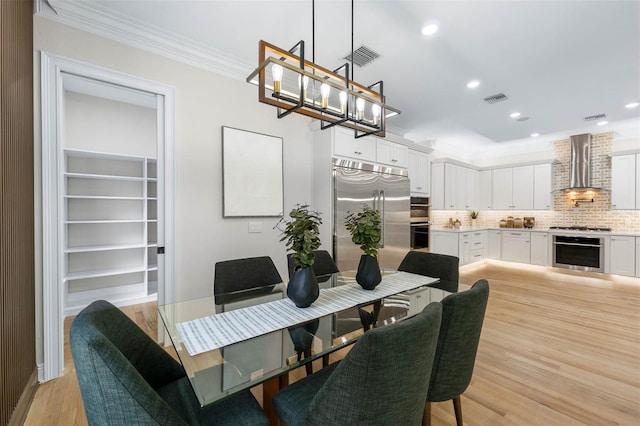 dining area featuring recessed lighting, ornamental molding, visible vents, and light wood-style floors