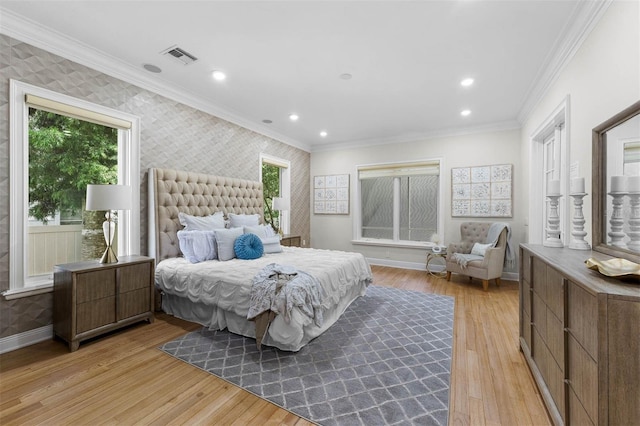 bedroom featuring wallpapered walls, light wood-style floors, baseboards, and visible vents