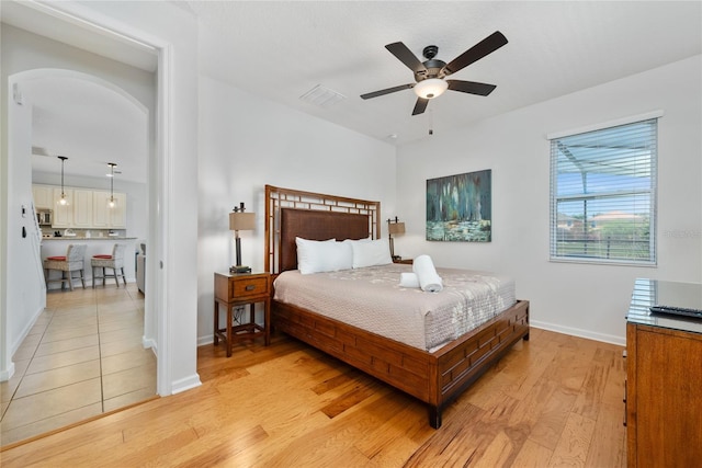 bedroom with ceiling fan and light hardwood / wood-style floors