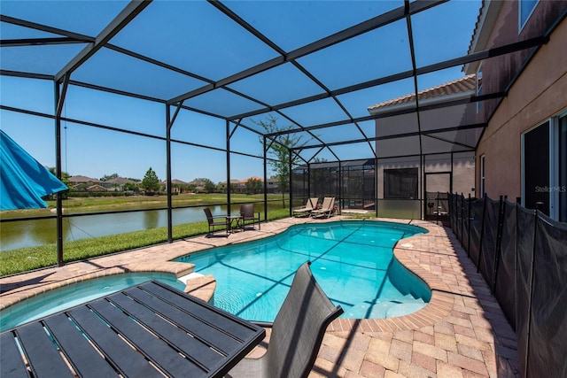 view of swimming pool with a patio, a water view, and glass enclosure