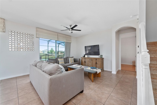 tiled living room featuring ceiling fan