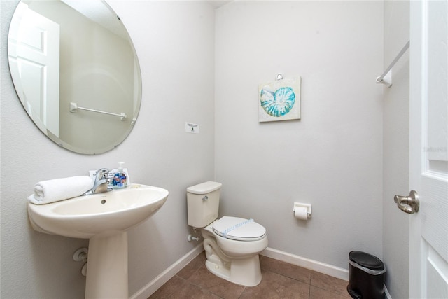 bathroom with tile patterned floors and toilet