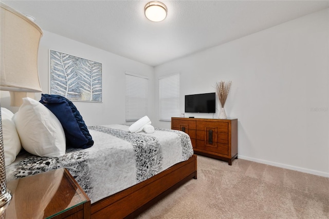 bedroom with light colored carpet