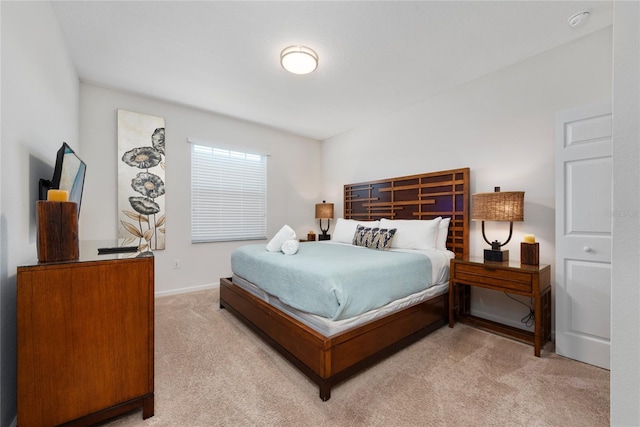 bedroom featuring light carpet