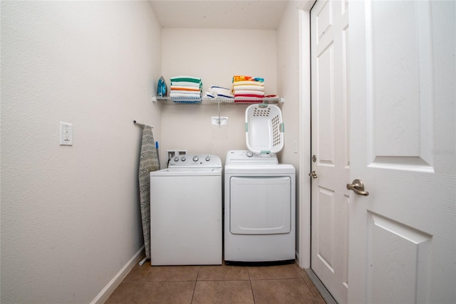 laundry room featuring light tile patterned flooring and washer and dryer