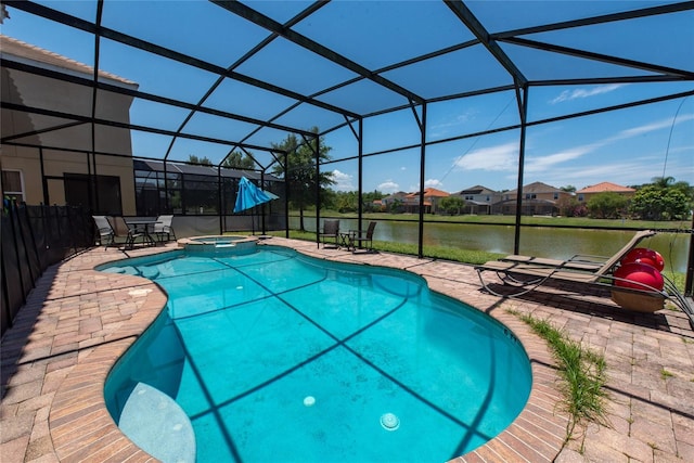 view of swimming pool featuring a lanai, a patio area, an in ground hot tub, and a water view