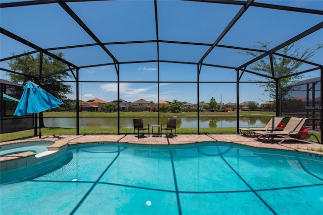 view of swimming pool with an in ground hot tub, a water view, glass enclosure, and a patio area