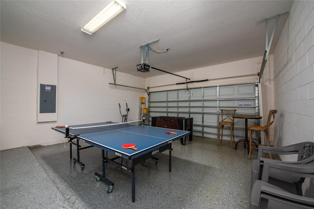 playroom featuring a textured ceiling and electric panel