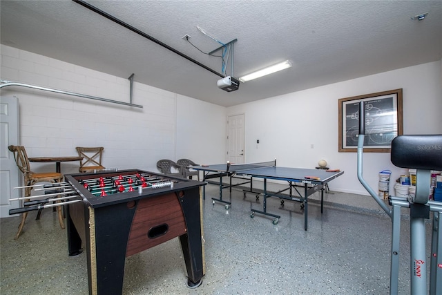 recreation room featuring a textured ceiling