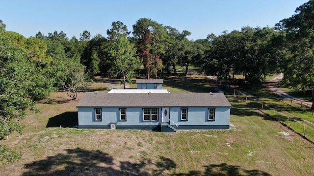 back of property featuring a lawn