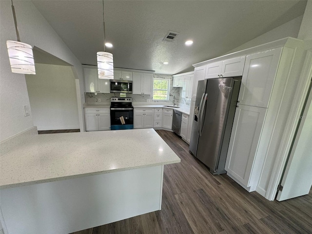 kitchen with white cabinetry, hanging light fixtures, vaulted ceiling, and appliances with stainless steel finishes