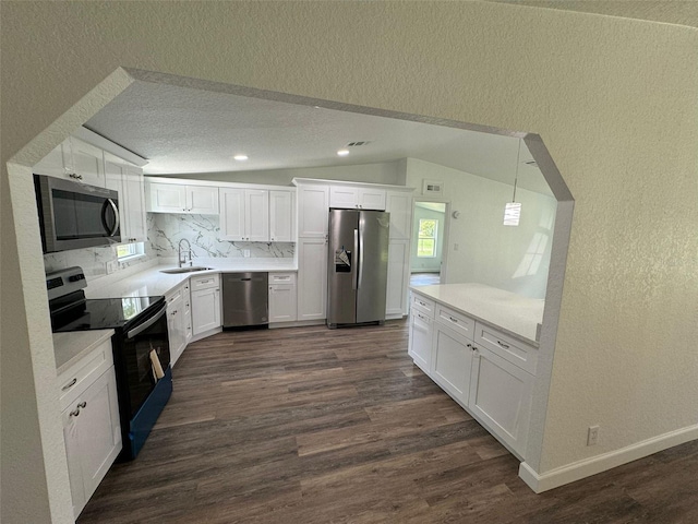 kitchen with white cabinetry, sink, tasteful backsplash, and appliances with stainless steel finishes