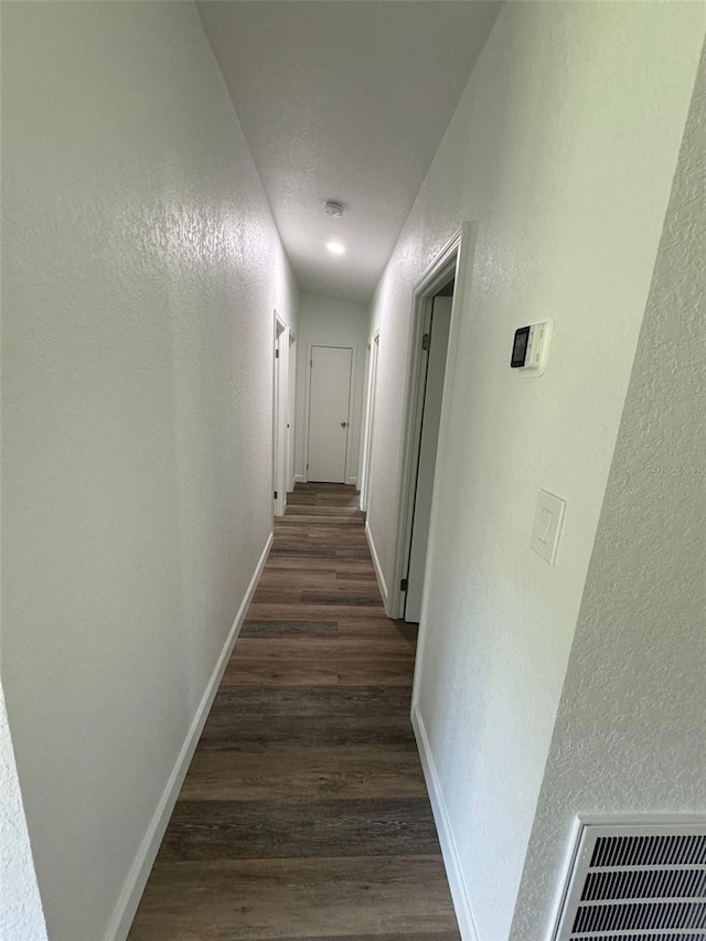 corridor with dark wood-type flooring