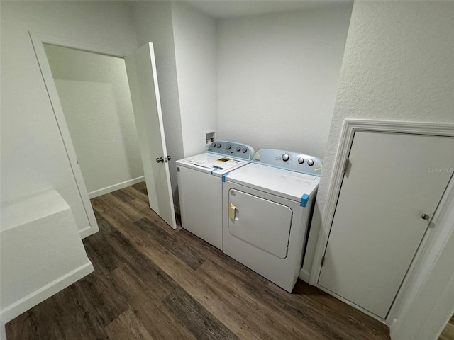 washroom with dark wood-type flooring and separate washer and dryer