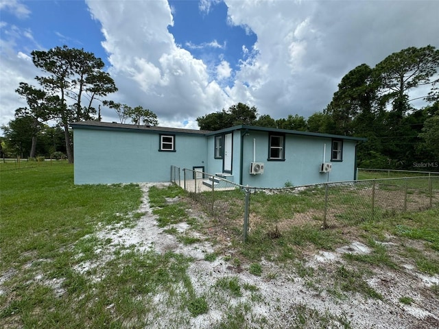 rear view of house featuring a yard